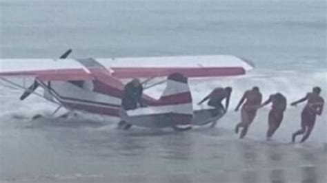 Small plane towing banner lands in ocean off crowded New Hampshire beach; pilot unhurt